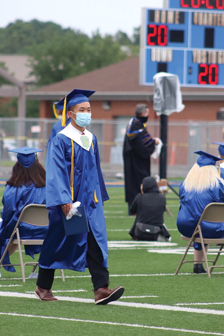 Graduate Richard Pan strolls back to his seat after receiving his diploma Saturday at Crawfordsville High School.
